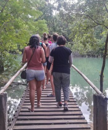 Volunteers walking over bridge on Palawan island
